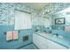 Retro bathroom with blue tile, floral wallpaper, and a pink sink at 46 Chadwick Dr, Charleston, SC 29407