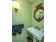 Charming bathroom with pedestal sink and ornate mirror at 46 Chadwick Dr, Charleston, SC 29407
