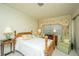 Cozy bedroom with wooden bed frame, nightstands, and a seating area at 46 Chadwick Dr, Charleston, SC 29407
