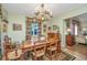 Bright dining room with a rustic wooden table and floral curtains at 46 Chadwick Dr, Charleston, SC 29407