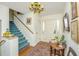Bright entryway with hardwood floors, blue staircase, and decorative table at 46 Chadwick Dr, Charleston, SC 29407