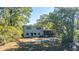 House back view, showcasing a screened porch and mature trees at 46 Chadwick Dr, Charleston, SC 29407