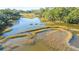 Aerial view of a peaceful marsh featuring calm waters and marsh grasses at 46 Chadwick Dr, Charleston, SC 29407
