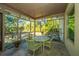 Bright screened porch with small table and chairs at 46 Chadwick Dr, Charleston, SC 29407
