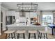 Modern kitchen with stainless steel appliances, white cabinets, and a large island at 476 Rowley Lane, Summerville, SC 29486