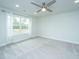 Bright bedroom featuring gray carpet, a window and ceiling fan at 5017 Cranesbill Way, Johns Island, SC 29455