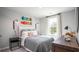 Bedroom with gray bedding, wood dresser, and two skateboards on wall at 503 Frutchey Ct, Summerville, SC 29486