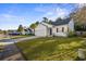 White house with gray roof, two car garage and yard, on a tree-lined street at 66 Creek Bend Dr, Summerville, SC 29485