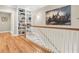 Upstairs hallway with built-in shelving and hardwood floors at 8553 Refuge Pointe Cir, Charleston, SC 29420