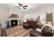 Living room with fireplace, brown leather furniture, and large TV at 9684 Islesworth Way, Summerville, SC 29485