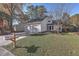 White house with two-car garage and well-manicured lawn at 104 Lewisfield Dr, North Charleston, SC 29418