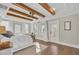 Bright main bedroom with wood beams, hardwood floors, and access to a porch at 149 Low Tide Ct, Charleston, SC 29492