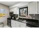 Modern kitchen with stainless steel appliances and dark countertops at 158 High Hammock Villas, Seabrook Island, SC 29455