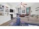 Living room with sectional sofa, hardwood floors, and built-in shelving at 2514 Myrtle Ave, Sullivans Island, SC 29482