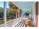 Side porch view with white railings and palm trees at 2514 Myrtle Ave, Sullivans Island, SC 29482