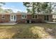 Brick home with a backyard, patio, and central air conditioning unit at 301 Corey Blvd, Summerville, SC 29483