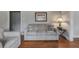 Living room with gray sofa and hardwood floors at 301 Corey Blvd, Summerville, SC 29483