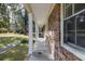 Brick covered side porch with white columns and view of yard at 301 Corey Blvd, Summerville, SC 29483