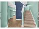 Two-story entryway with light teal walls, hardwood floors, and a carpeted staircase at 3028 Adventure Way, Ladson, SC 29456