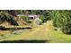 Landscaped backyard with mature trees and shrubs at 3112 Santee River Rd, Saint Stephen, SC 29479