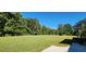 Large grassy backyard with a basketball hoop at 3112 Santee River Rd, Saint Stephen, SC 29479