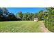 Large backyard with grassy area and storage building at 3112 Santee River Rd, Saint Stephen, SC 29479