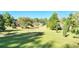 Landscaped backyard with mature trees and shrubs at 3112 Santee River Rd, Saint Stephen, SC 29479