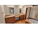 Bathroom with double sinks, a soaking tub and wood cabinets at 3112 Santee River Rd, Saint Stephen, SC 29479