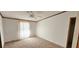 Spacious bedroom with ceiling fan, large window, and neutral carpeting at 3112 Santee River Rd, Saint Stephen, SC 29479