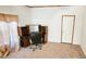 Home office space with built-in desk and neutral carpet at 3112 Santee River Rd, Saint Stephen, SC 29479