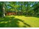 Large backyard with trampoline and spacious green lawn, partially shaded by large trees at 314 Heber Rd, Summerville, SC 29485