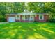 Brick ranch house with white trim, lush lawn, and mature trees at 314 Heber Rd, Summerville, SC 29485