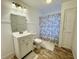 Clean bathroom with white vanity, shower, and tile floor at 405 W Carolina Ave, Varnville, SC 29944