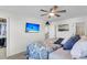 Bedroom with king bed, mounted TV, and adjacent bathroom at 413 Snowy Plover Ln, Summerville, SC 29486