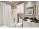Clean bathroom with a shower/tub combo, white vanity, and dark granite countertop at 456 Vetch Ct, Kiawah Island, SC 29455