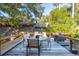 Spacious deck with seating, grill, and views of surrounding trees at 456 Vetch Ct, Kiawah Island, SC 29455