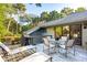 Relaxing deck features lounge chairs, dining table, and built-in grill at 456 Vetch Ct, Kiawah Island, SC 29455