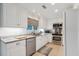 Modern kitchen with white cabinets, granite counters, and stainless steel appliances at 456 Vetch Ct, Kiawah Island, SC 29455