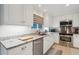 Modern kitchen with white cabinets, granite counters, and stainless steel appliances at 456 Vetch Ct, Kiawah Island, SC 29455
