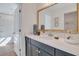 Bathroom with dark vanity, white countertop, and large mirror at 463 Rowley Lane, Summerville, SC 29486