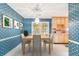 Bright dining room with blue patterned wallpaper and wooden table at 648 Schooner Rd, Charleston, SC 29412