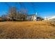 Large backyard with dry grass and a wooden fence at 7011 Windmill Creek Rd, Charleston, SC 29414