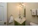 Small bathroom with green vanity, mirror, and fresh towels at 7011 Windmill Creek Rd, Charleston, SC 29414