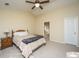 Main bedroom with a ceiling fan and en-suite bathroom at 7011 Windmill Creek Rd, Charleston, SC 29414