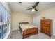 Bedroom with a queen bed, wooden dresser, and window with blinds at 7011 Windmill Creek Rd, Charleston, SC 29414