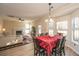 Bright dining area with red table cloth and view of living room and backyard at 7011 Windmill Creek Rd, Charleston, SC 29414