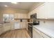 Kitchen with white cabinets, stainless steel appliances, and light wood floors at 7011 Windmill Creek Rd, Charleston, SC 29414