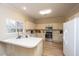 Kitchen features white cabinets, stainless steel appliances and ample counter space at 7011 Windmill Creek Rd, Charleston, SC 29414