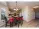 Kitchen and breakfast nook with red tablecloth and hardwood floors at 7011 Windmill Creek Rd, Charleston, SC 29414