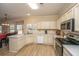 Open kitchen with island, white cabinets, and stainless steel appliances at 7011 Windmill Creek Rd, Charleston, SC 29414